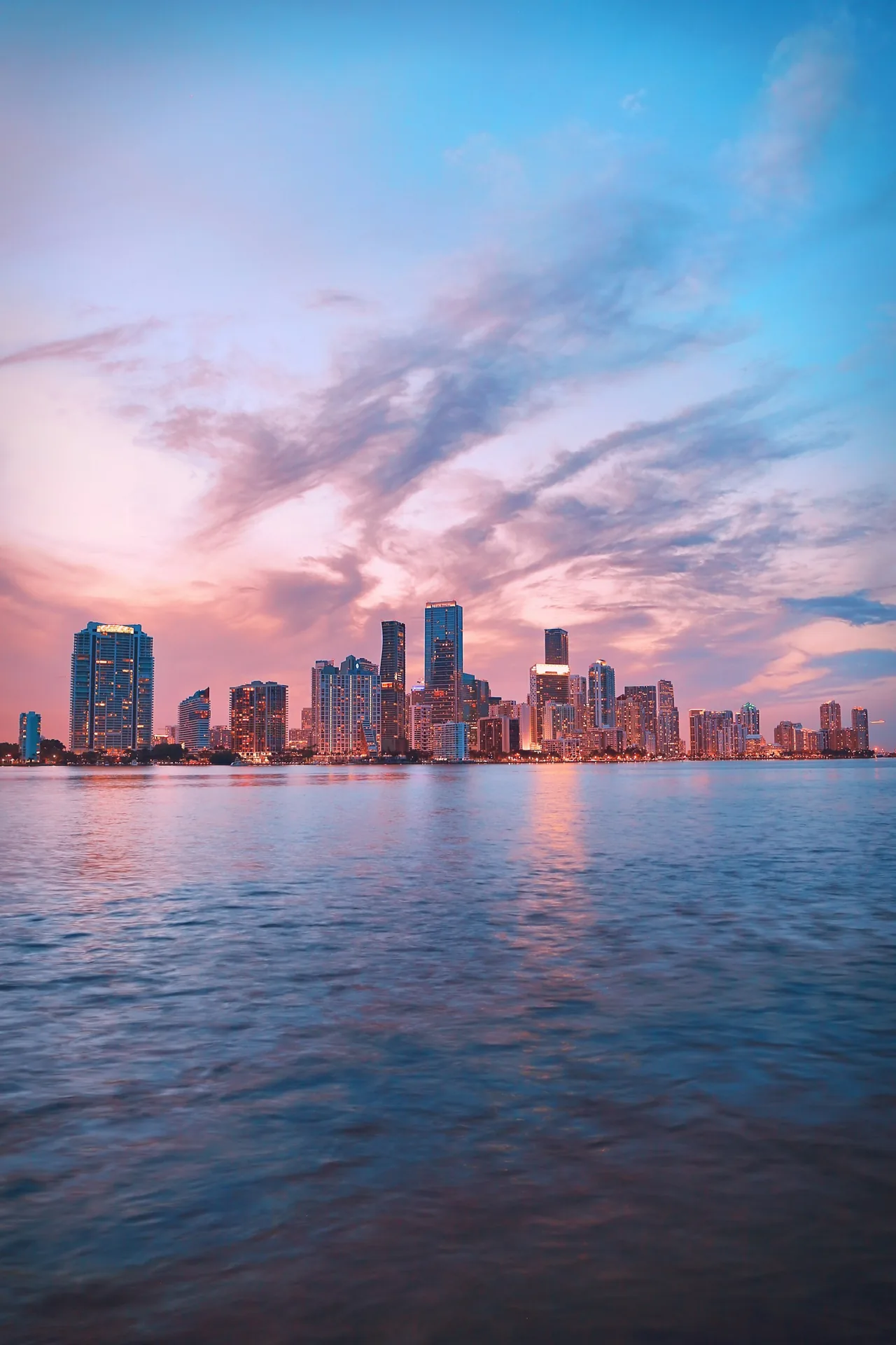Miami skyline over the water at dusk